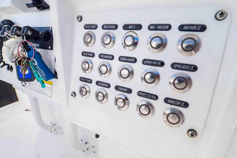 Slide: The Image of Control panel of a 2014 Intrepid 375 Walkaround boat with labeled buttons and keys. - 94