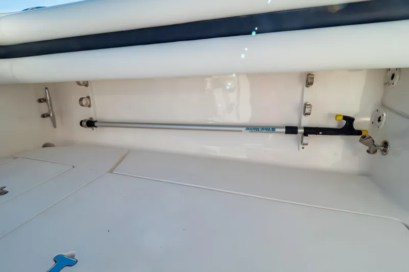 Slide: The Image of 2014 Intrepid 375 Walkaround boat interior with mounted equipment and storage space. - 96