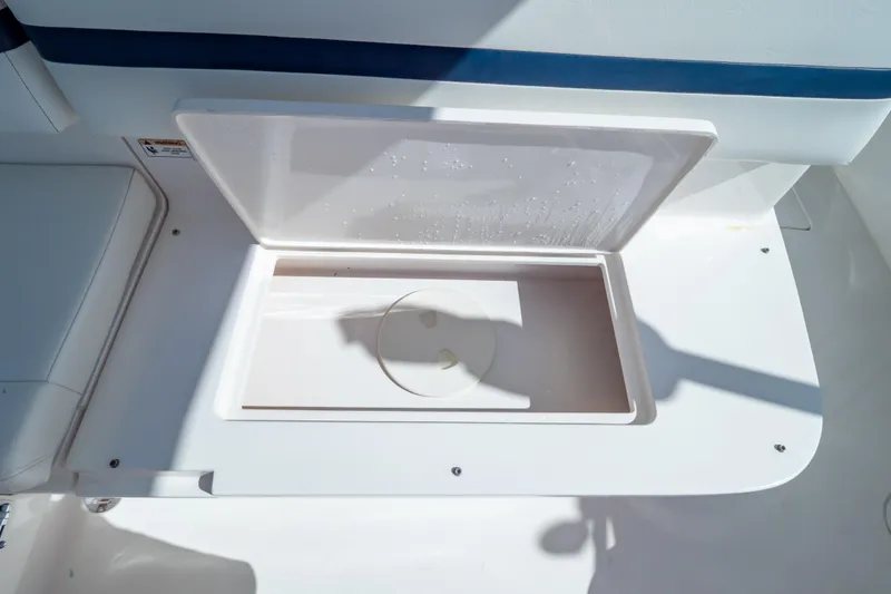Slide: The Image of Open storage compartment on 2014 Intrepid 375 Walkaround boat, featuring a clean white interior. - 97