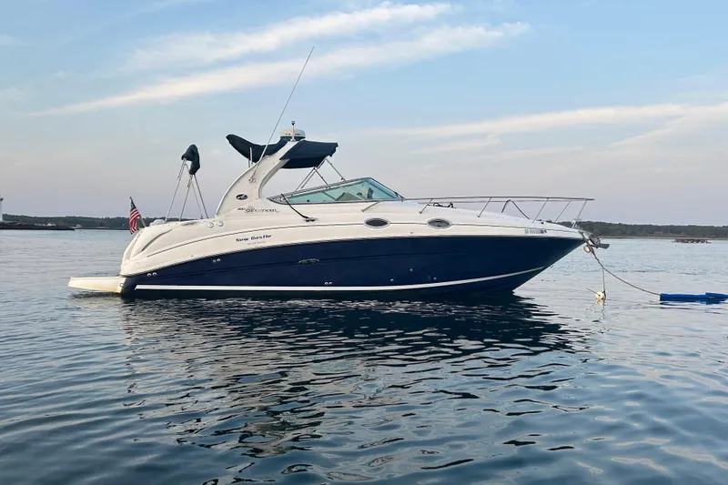 The Image of 2005 Sea Ray Sundancer 280 yacht anchored on calm water under a clear sky. - 0