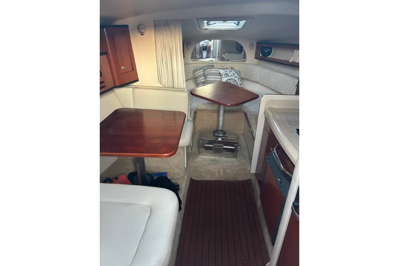 Slide: The Image of Interior of 2005 Sea Ray Sundancer 280, featuring cozy seating and wooden table. - 2