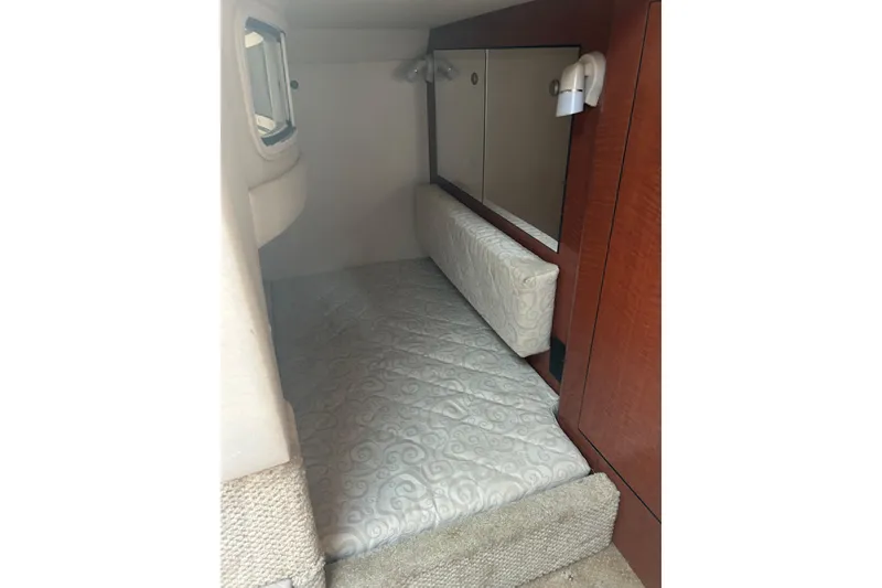 Slide: The Image of Interior cabin of 2005 Sea Ray Sundancer 280 with bed and wooden paneling. - 3
