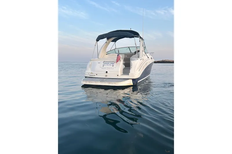 Slide: The Image of 2005 Sea Ray Sundancer 280 boat on calm water, rear view with American flag. - 5