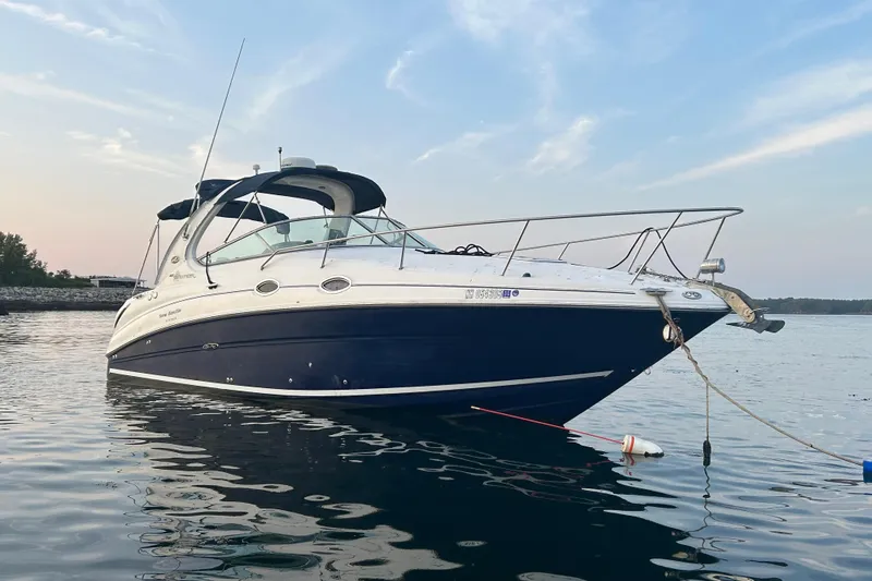 Slide: The Image of 2005 Sea Ray Sundancer 280 boat anchored on calm water at sunset. - 8