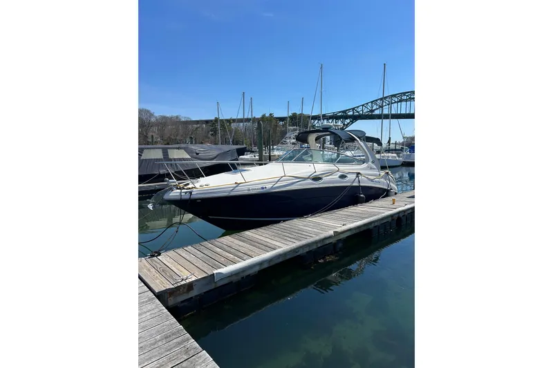 Slide: The Image of 2005 Sea Ray Sundancer 280 docked at marina under clear blue sky. - 9