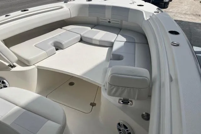 Slide: The Image of 2021 Mako 236 Center Console boat interior with cushioned seating and storage compartments. - 5