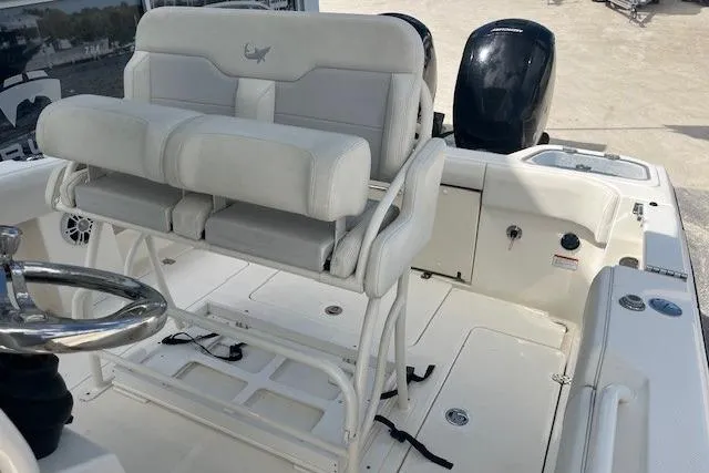 Slide: The Image of 2021 Mako 236 Center Console boat interior with dual seating and steering wheel. - 7