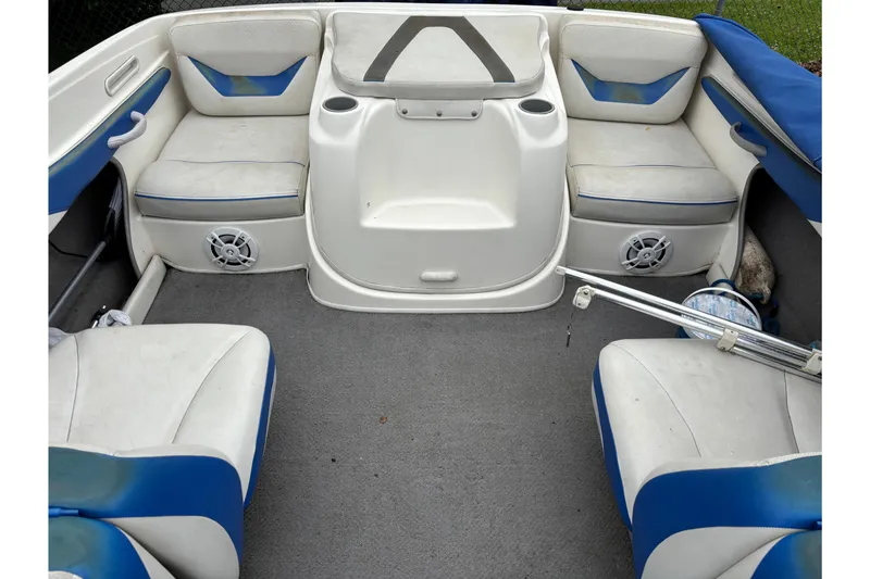 Slide: The Image of Interior of a 2006 Bayliner 205 boat with blue and white seating. - 9