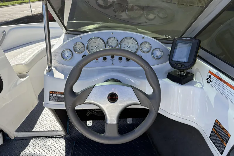 Slide: The Image of 2007 Bayliner 175 Bowrider dashboard with steering wheel and gauges. - 12