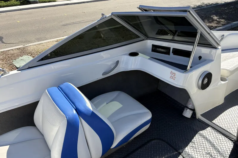 Slide: The Image of 2007 Bayliner 175 Bowrider interior with blue and white seating, dashboard, and windshield. - 13