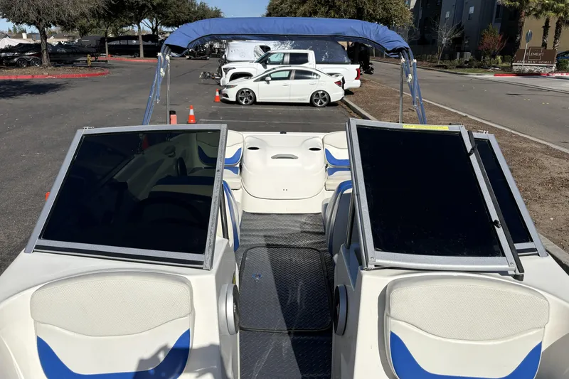 Slide: The Image of 2007 Bayliner 175 Bowrider with blue and white interior, parked outdoors. - 15