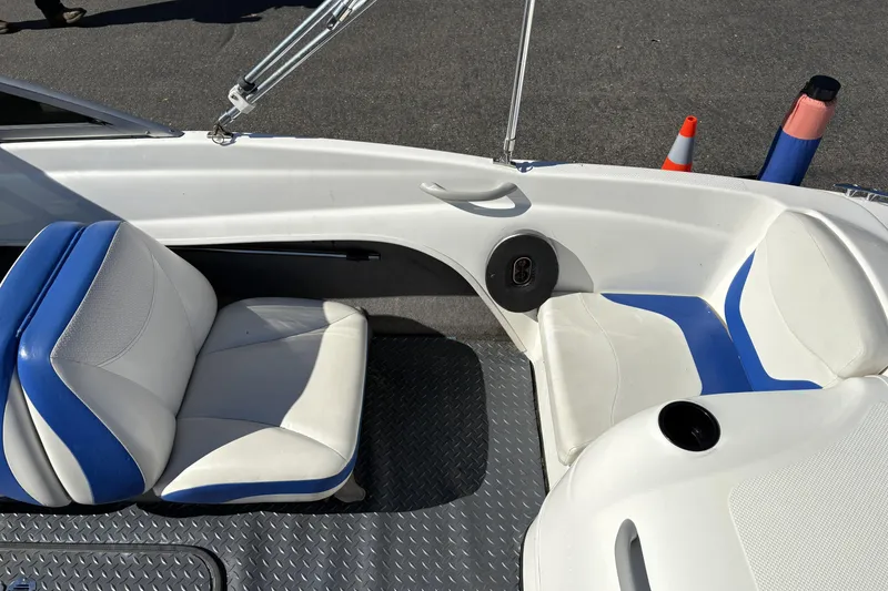 Slide: The Image of 2007 Bayliner 175 Bowrider interior with blue and white seating, speaker, and cup holder. - 17