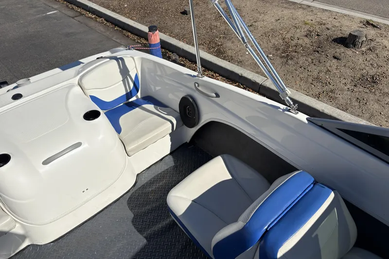 Slide: The Image of 2007 Bayliner 175 Bowrider interior with blue and white seating, cup holders, and speaker. - 18