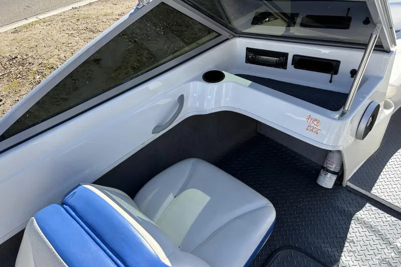 Slide: The Image of 2007 Bayliner 175 Bowrider interior with blue and white seating, dashboard, and cup holder. - 20