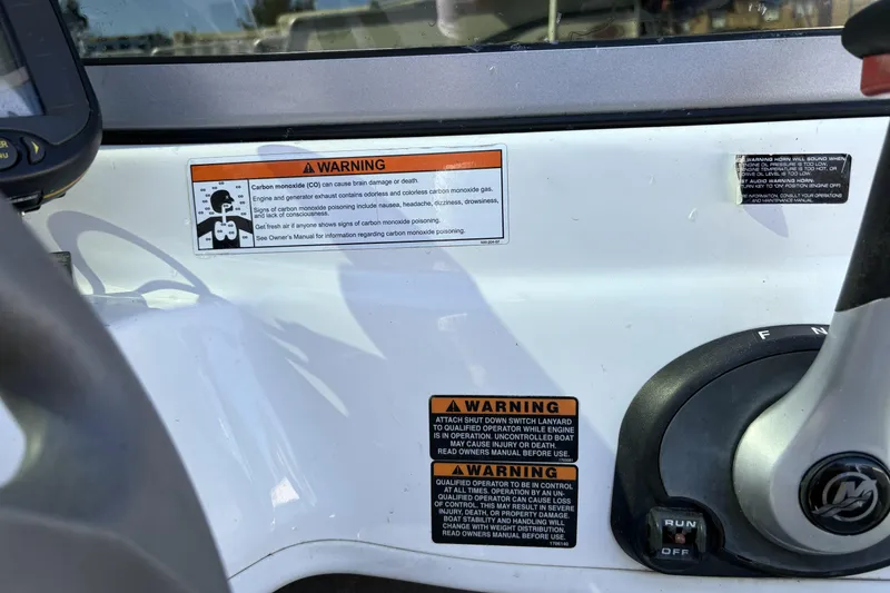 Slide: The Image of 2007 Bayliner 175 Bowrider dashboard with warning labels and control panel. - 21