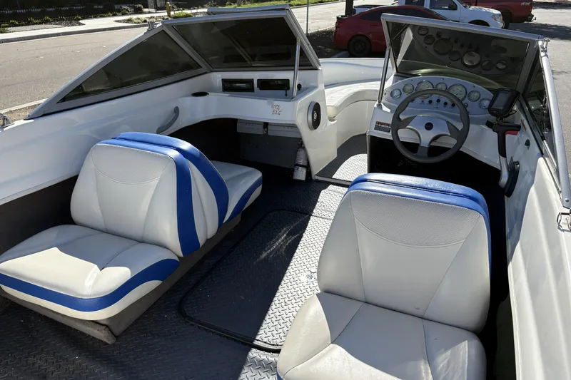 Slide: The Image of 2007 Bayliner 175 Bowrider interior with blue and white seating, steering wheel, and dashboard. - 25