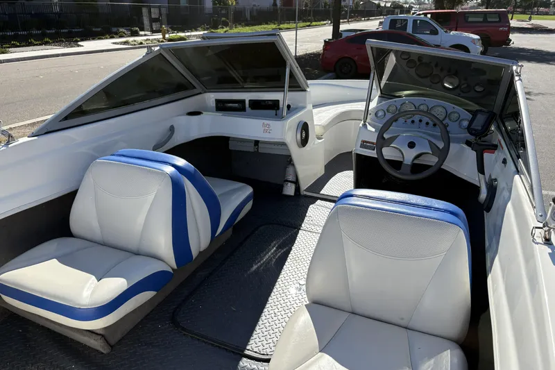 Slide: The Image of 2007 Bayliner 175 Bowrider interior with blue and white seating, steering wheel, and dashboard. - 26