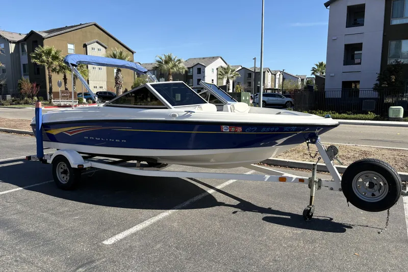 Slide: The Image of 2007 Bayliner 175 Bowrider boat on trailer in urban parking lot. - 3