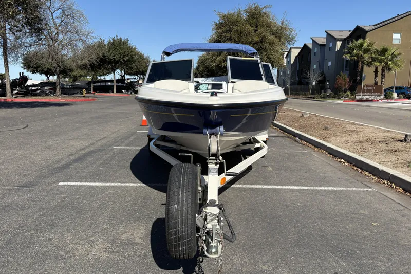 Slide: The Image of 2007 Bayliner 175 Bowrider on trailer in parking lot, sunny day. - 7