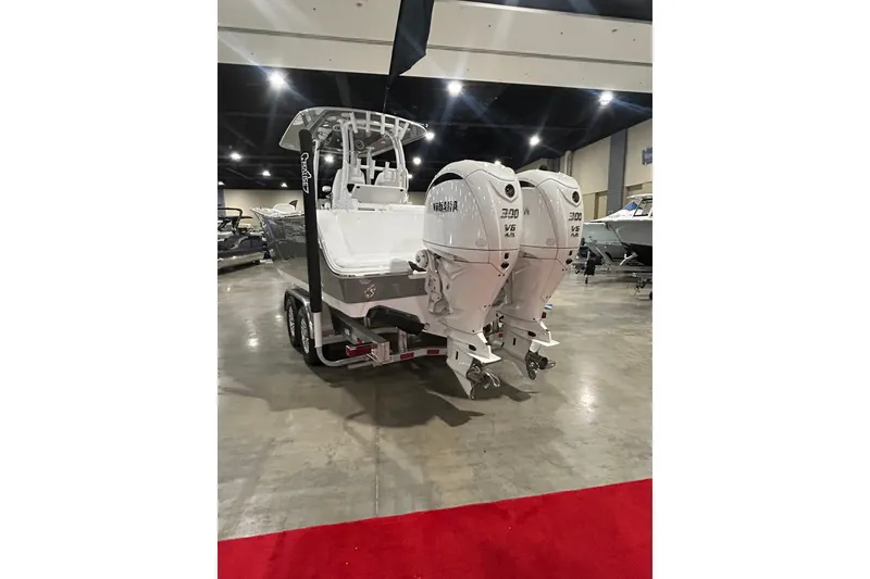 Slide: The Image of 2026 Sportsman Open 282 Center Console boat with twin engines on display indoors. - 10