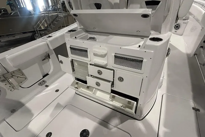 Slide: The Image of 2026 Sportsman Open 282 Center Console boat interior with open storage compartments and seating. - 12