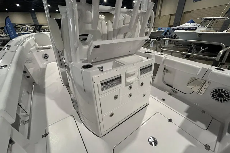 Slide: The Image of 2026 Sportsman Open 282 Center Console boat interior at a showroom display. - 13
