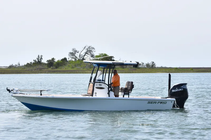 The Image of 2018 Sea Pro 248 Bay boat on water with Suzuki engine, scenic background. - 0