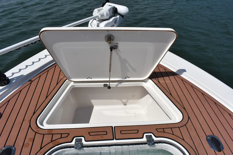 Slide: The Image of Open storage compartment on 2018 Sea Pro 248 Bay boat with teak flooring. - 10