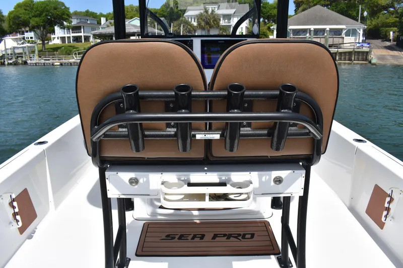 Slide: The Image of 2018 Sea Pro 248 Bay boat interior with rod holders and seating. - 15