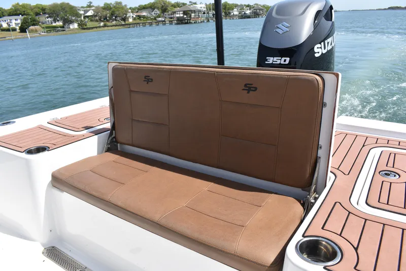 Slide: The Image of 2018 Sea Pro 248 Bay boat with brown seating and Suzuki 350 engine on water. - 17