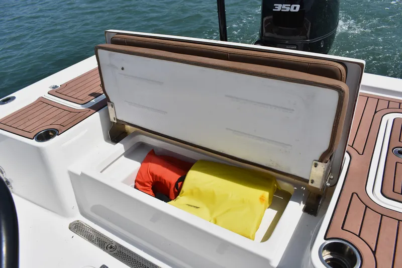 Slide: The Image of Open storage compartment on 2018 Sea Pro 248 Bay boat with life jackets inside. - 18