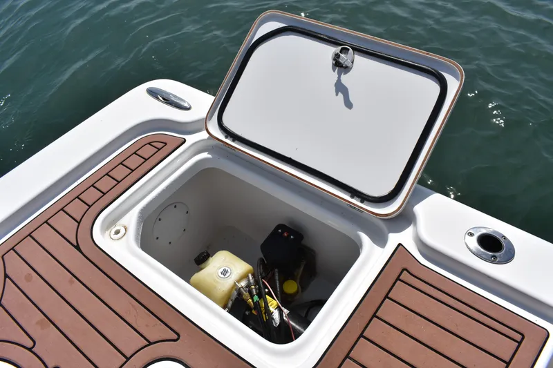 Slide: The Image of Open storage compartment on 2018 Sea Pro 248 Bay boat, showing interior equipment. - 21