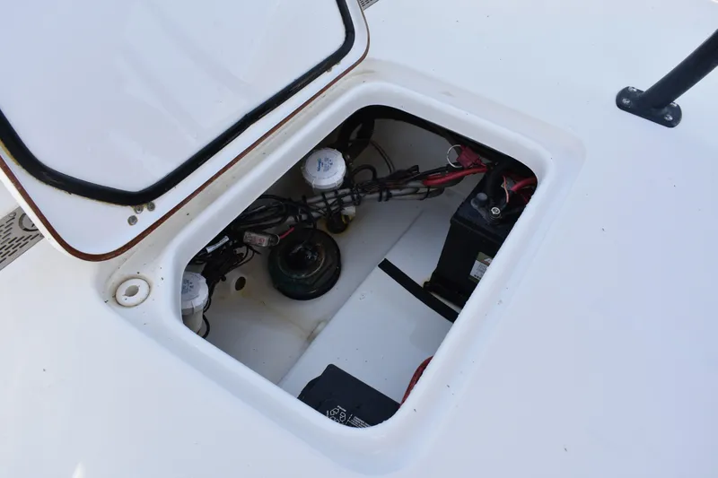 Slide: The Image of Open hatch of a 2018 Sea Pro 248 Bay boat showing internal wiring and battery. - 23