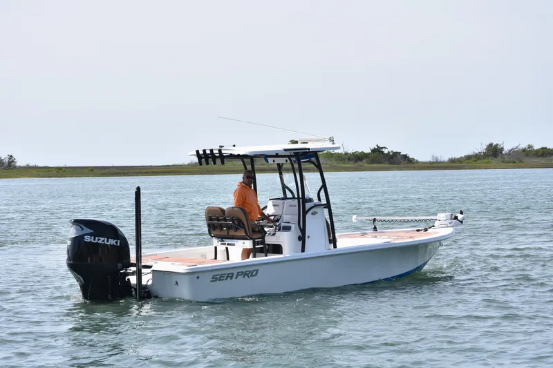 Slide: The Image of 2018 Sea Pro 248 Bay boat with Suzuki engine on calm water. - 3