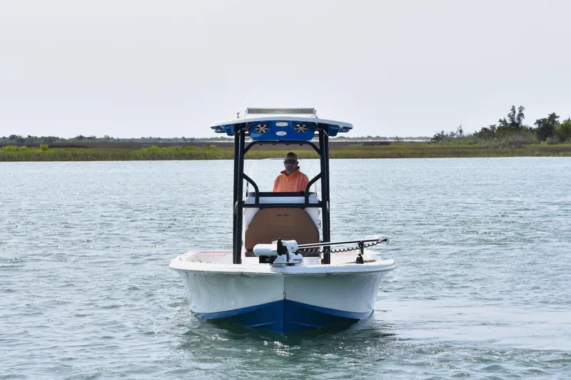 Slide: The Image of 2018 Sea Pro 248 Bay boat on water with person steering. - 5