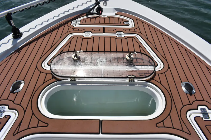 Slide: The Image of 2018 Sea Pro 248 Bay boat deck with open storage compartment. - 9