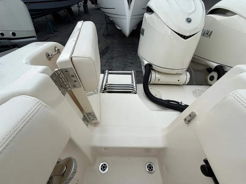 Slide: The Image of The image shows the stern of a Grady-White Canyon 306 boat with two Yamaha engines. - 14