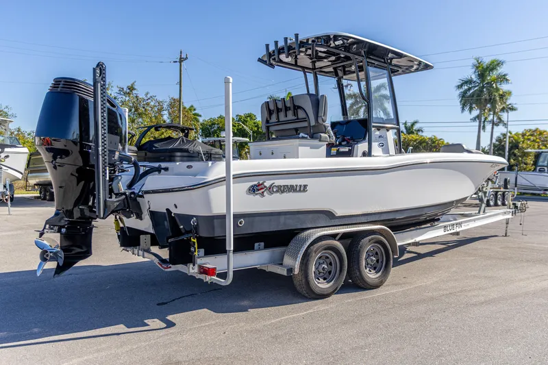 Slide: The Image of 2022 Crevalle 26 HCO boat on trailer, featuring sleek design and powerful outboard motor. - 10