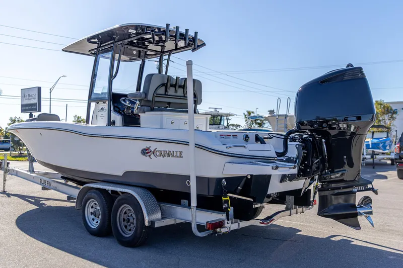Slide: The Image of 2022 Crevalle 26 HCO boat on trailer, featuring powerful outboard motor. - 11