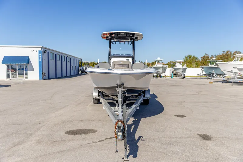 Slide: The Image of 2022 Crevalle 26 HCO boat on trailer in sunny marina setting. - 14