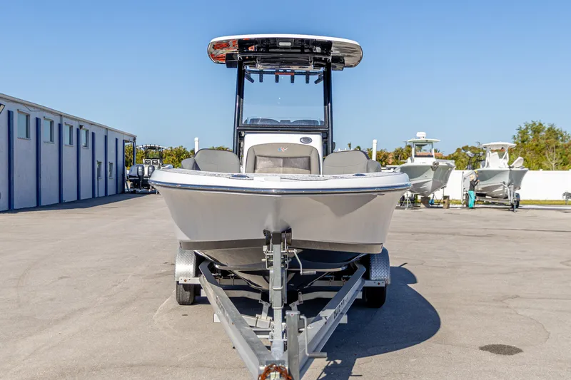 Slide: The Image of 2022 Crevalle 26 HCO boat on trailer in sunny marina setting. - 15