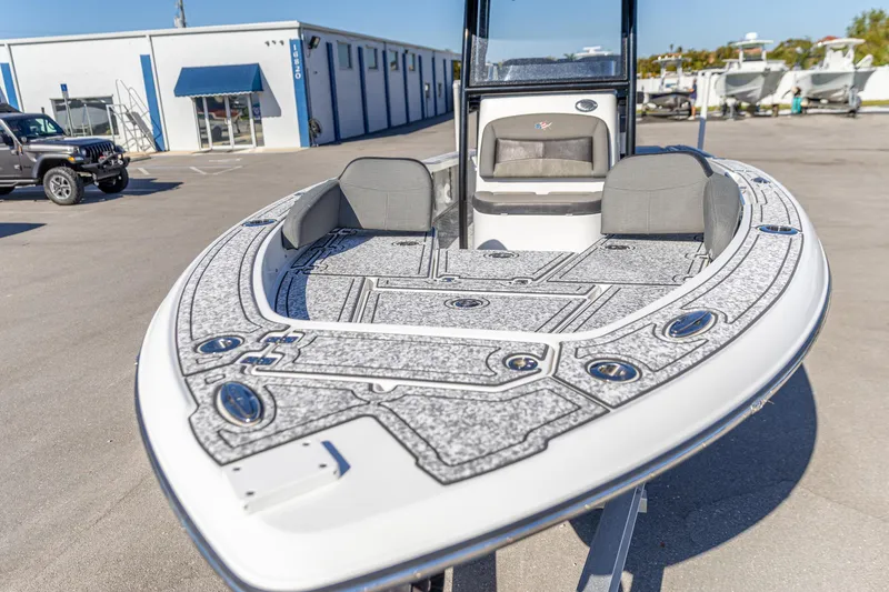 Slide: The Image of 2022 Crevalle 26 HCO boat with spacious deck and seating in a marina setting. - 16