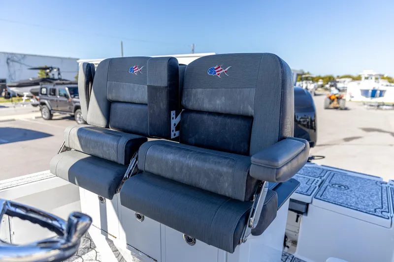 Slide: The Image of Dual seats on 2022 Crevalle 26 HCO boat, featuring sleek design and comfortable armrests. - 4