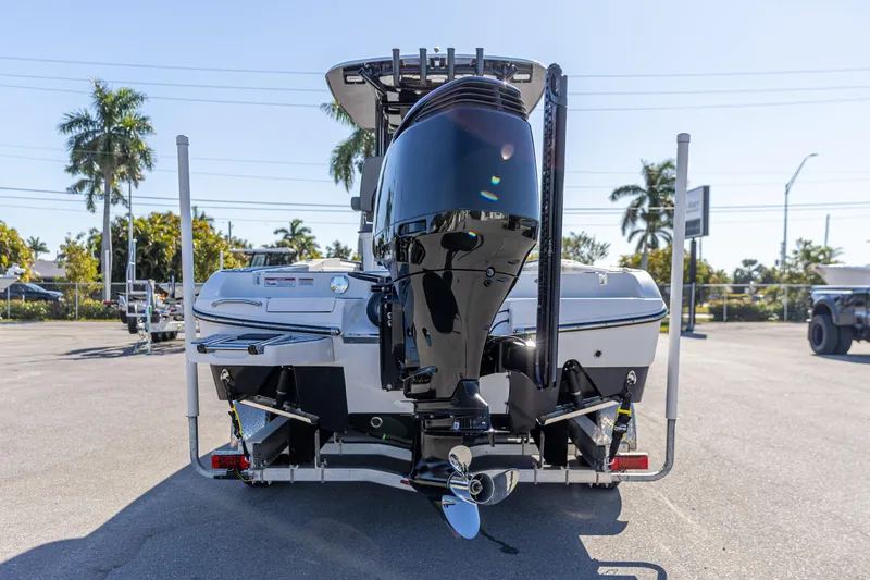 Slide: The Image of 2022 Crevalle 26 HCO boat rear view with outboard motor in sunny setting. - 6
