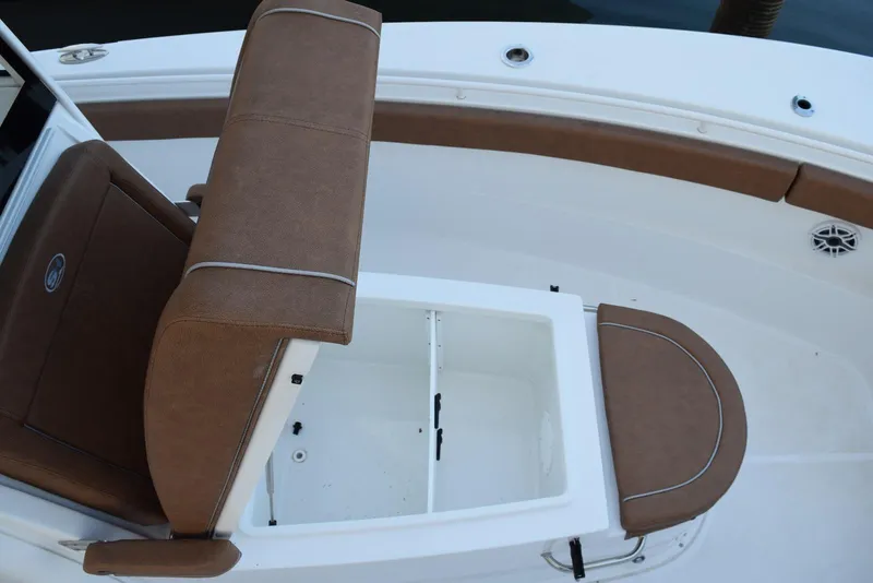 Slide: The Image of 2025 Sea Hunt Gamefish 28 Coffin Box interior with brown seating and storage compartment. - 13