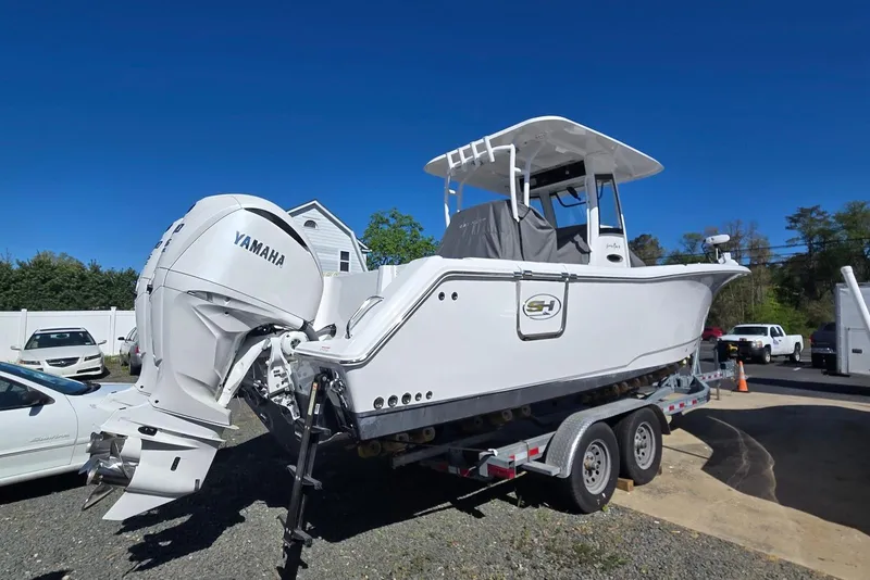 Slide: The Image of 2025 Sea Hunt Gamefish 28 Coffin Box boat on trailer with Yamaha engine. - 17