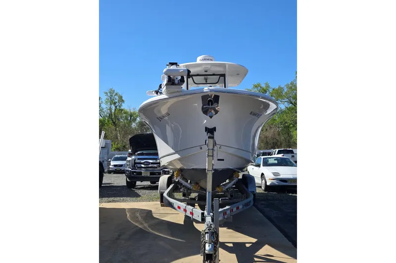 Slide: The Image of 2025 Sea Hunt Gamefish 28 Coffin Box boat on trailer, front view, clear sky background. - 18