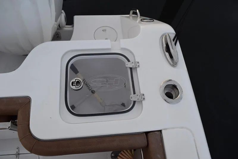 Slide: The Image of 2025 Sea Hunt Gamefish 28 Coffin Box boat detail with storage compartment and rod holder. - 5