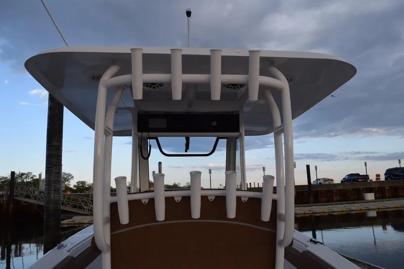 Slide: The Image of 2025 Sea Hunt Gamefish 28 Coffin Box boat with rod holders at dockside. - 6