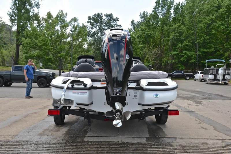 Slide: The Image of 2025 Nitro Z17 boat on trailer at a boat ramp, surrounded by trees and vehicles. - 12